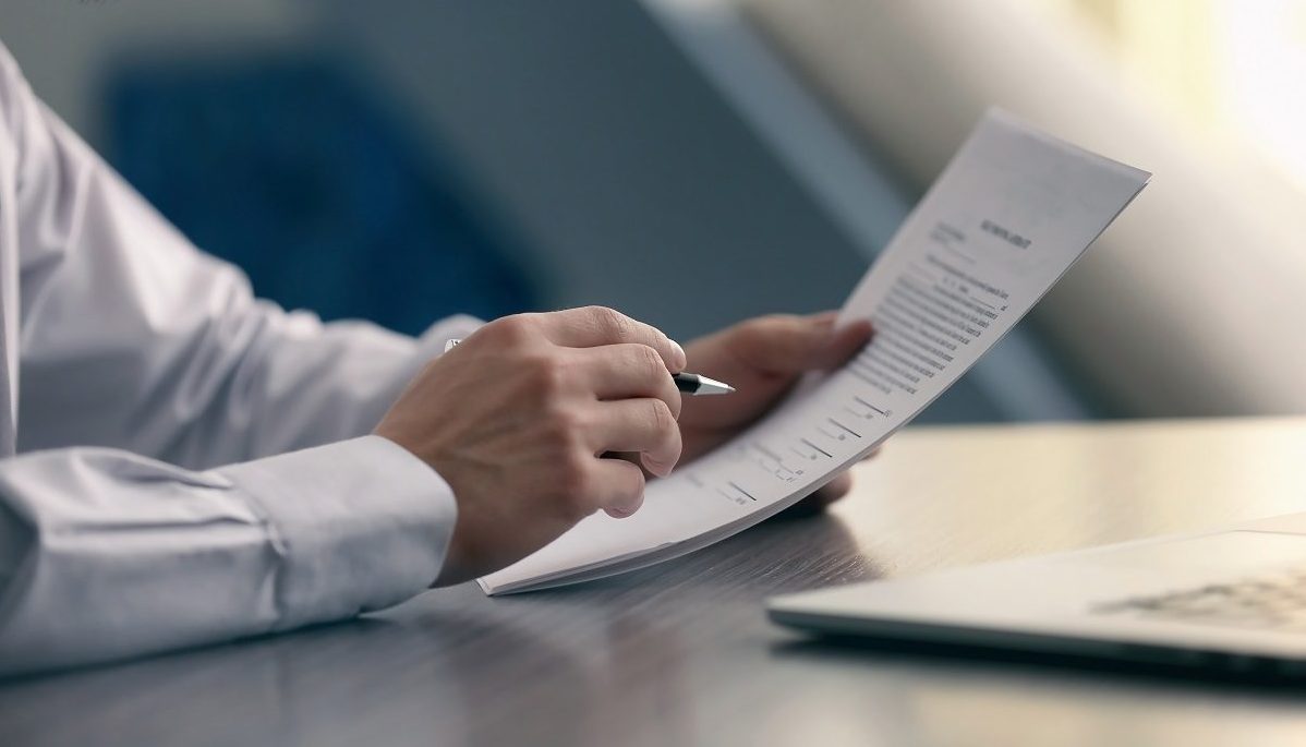 Businessman reading documents; Shutterstock ID 543880450; PO: blog