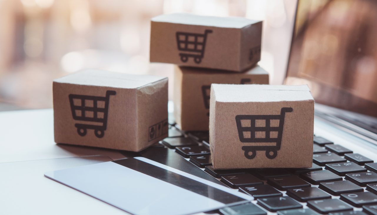 1939658200 Shopping online. Credit card and cardboard box with a shopping cart logo on laptop keyboard. Shopping service on The online web. offers home delivery