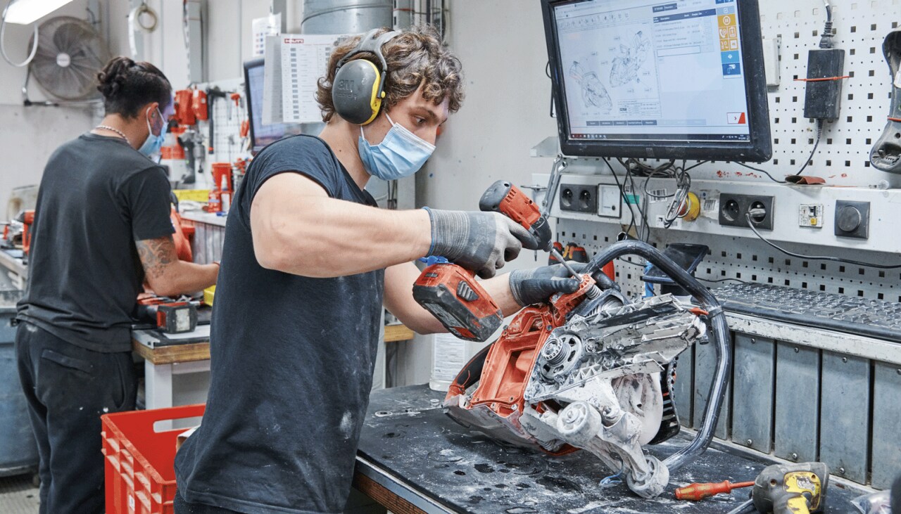 Een Hilti-technicus repareert een machine in een reparatiecentrum